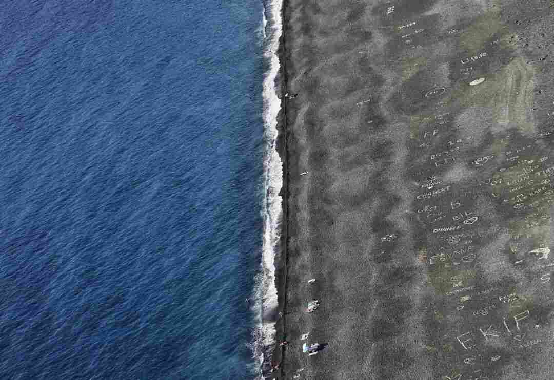 a plane flying over a beach